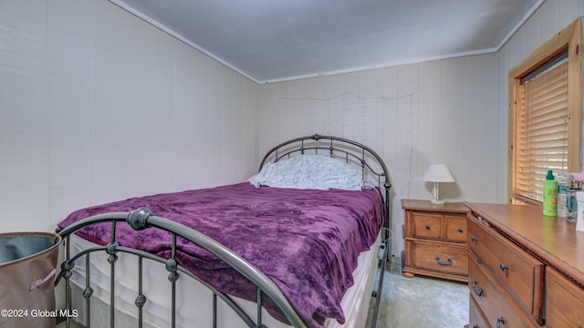 bedroom featuring light colored carpet and crown molding