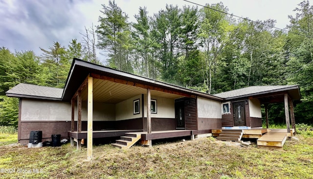 rear view of house featuring covered porch