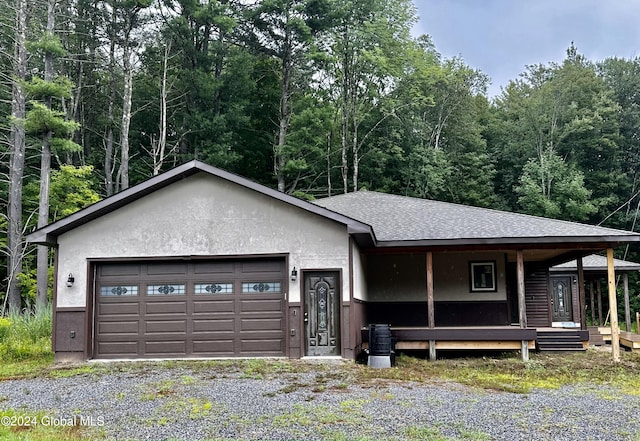 view of front of property with a garage and cooling unit