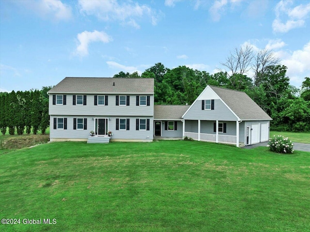 colonial inspired home featuring a garage and a front yard