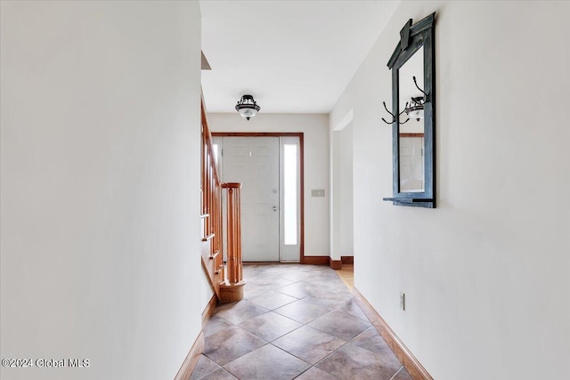 hall with light tile patterned floors