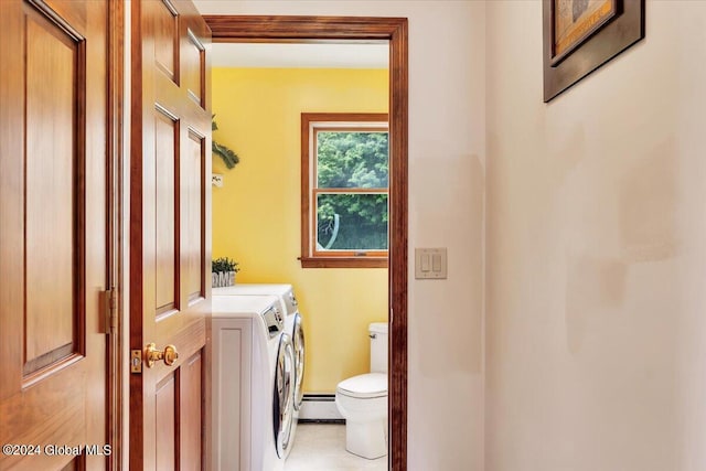 bathroom featuring tile patterned flooring, a baseboard heating unit, toilet, vanity, and washing machine and dryer