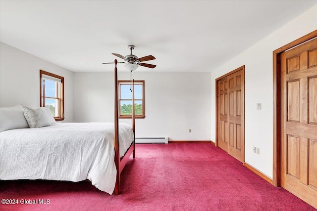 bedroom featuring carpet floors, ceiling fan, multiple windows, and baseboard heating