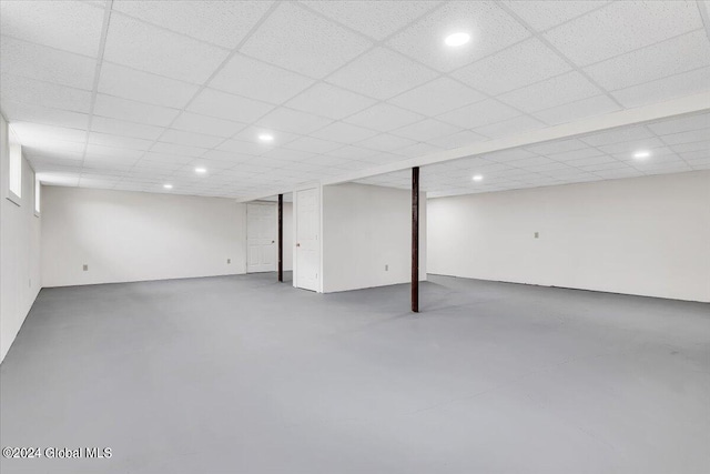 basement with a paneled ceiling