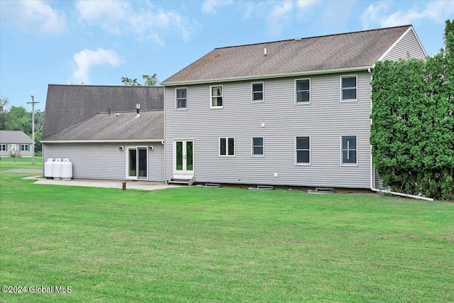 rear view of property featuring a patio area and a yard