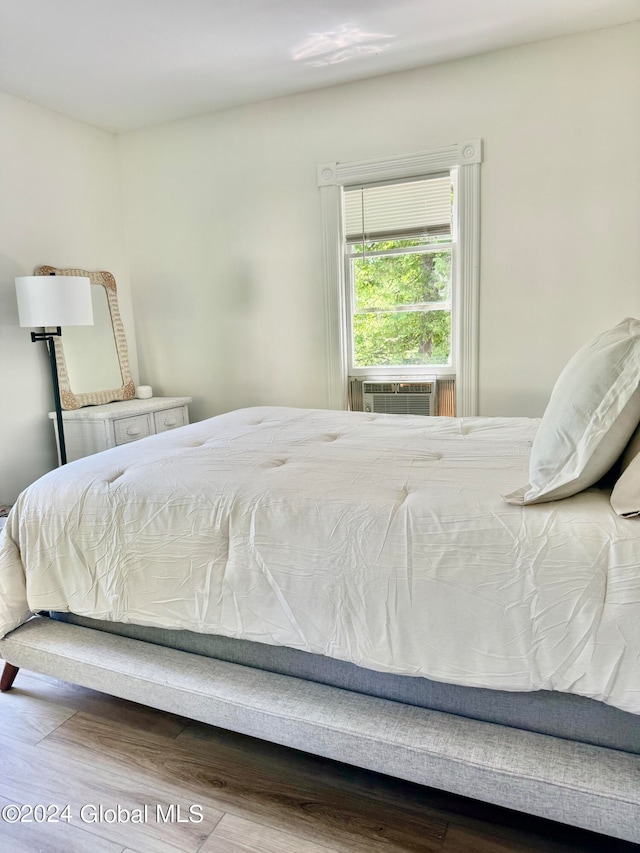 bedroom with wood-type flooring and cooling unit