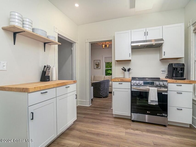 kitchen featuring light hardwood / wood-style floors, stainless steel stove, white cabinetry, and wooden counters