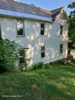 view of side of home featuring a lawn