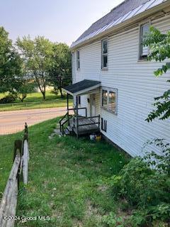 view of side of property with a yard