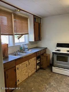 kitchen featuring white electric range and sink