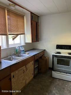 kitchen featuring sink and white electric range oven