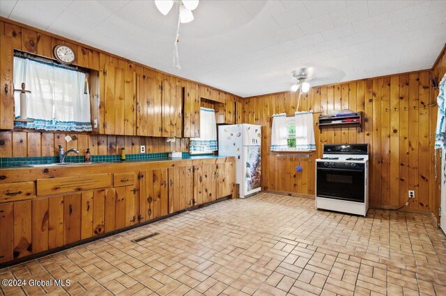 kitchen with extractor fan, white appliances, and ceiling fan