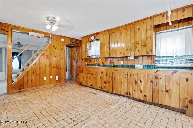 kitchen with ceiling fan and tasteful backsplash