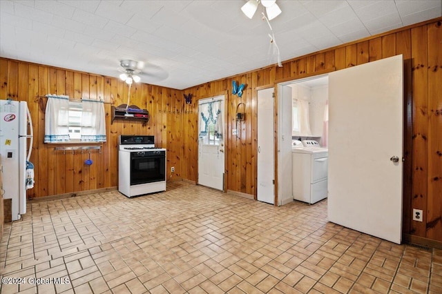 kitchen featuring wood walls, exhaust hood, ceiling fan, and white appliances