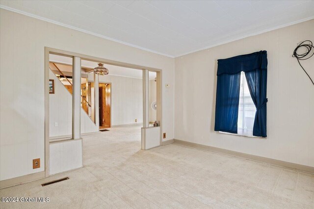 carpeted empty room with ornamental molding