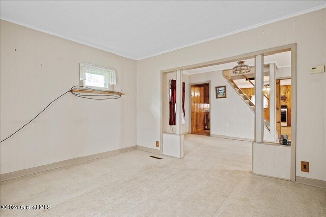 carpeted empty room featuring ornamental molding