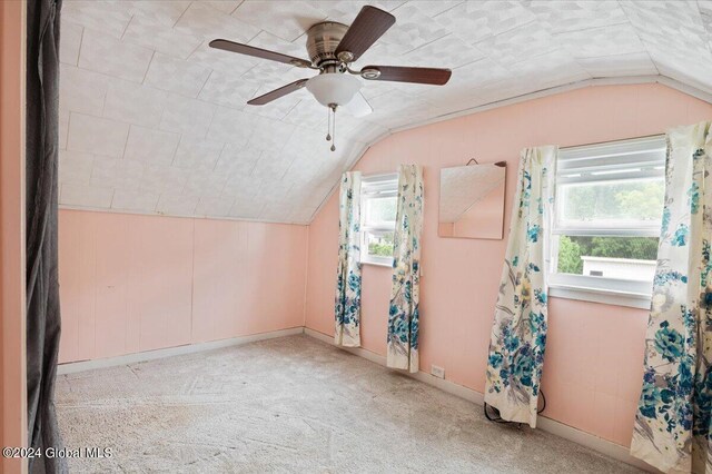 bonus room with light carpet, lofted ceiling, ceiling fan, and plenty of natural light