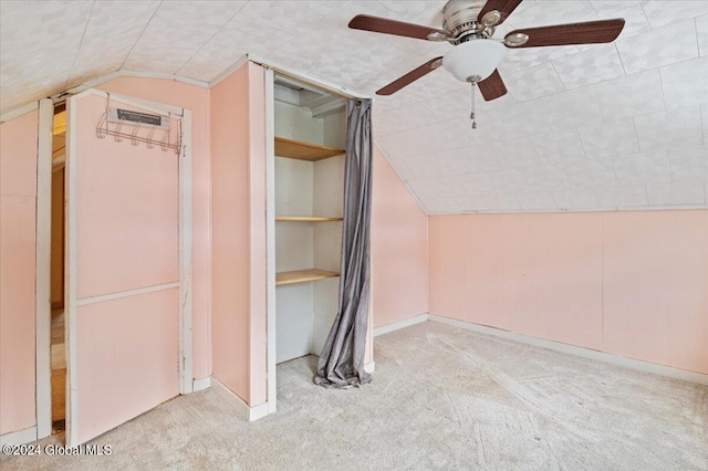 interior space with lofted ceiling, carpet, a closet, and ceiling fan