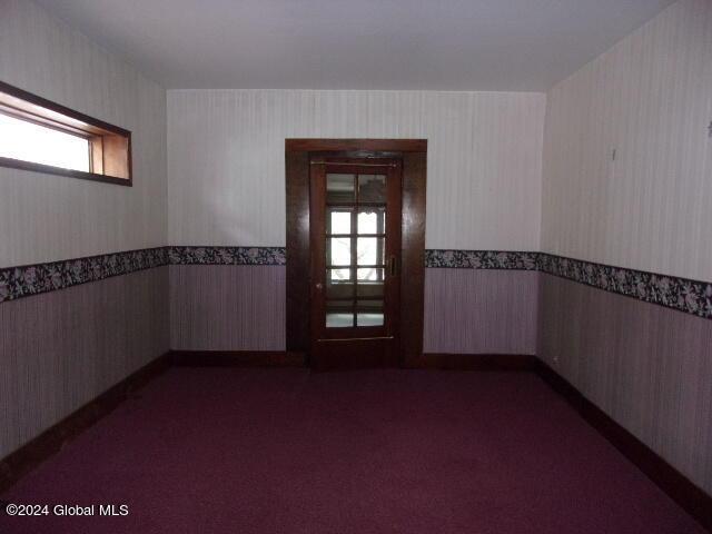 2119 Broadway, Schenectady, NY 12306 - unfurnished room with wallpapered walls, carpet floors, plenty of natural light, and wainscoting