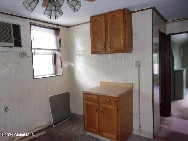 2119 Broadway, Schenectady, NY 12306 - kitchen featuring light countertops, a wall mounted air conditioner, ceiling fan, and brown cabinets