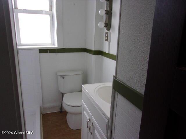 2119 Broadway, Schenectady, NY 12306 - bathroom with wood finished floors, toilet, and vanity