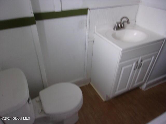 2119 Broadway, Schenectady, NY 12306 - half bath featuring toilet, vanity, and wood finished floors