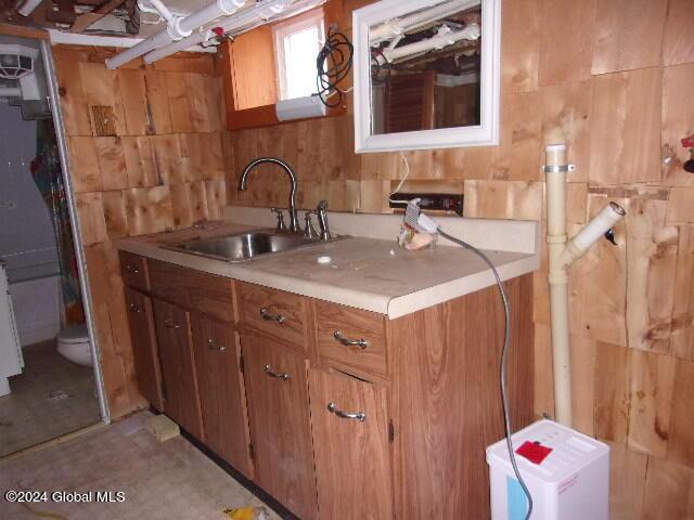 2119 Broadway, Schenectady, NY 12306 - interior space with tile walls, light countertops, a sink, and brown cabinetry