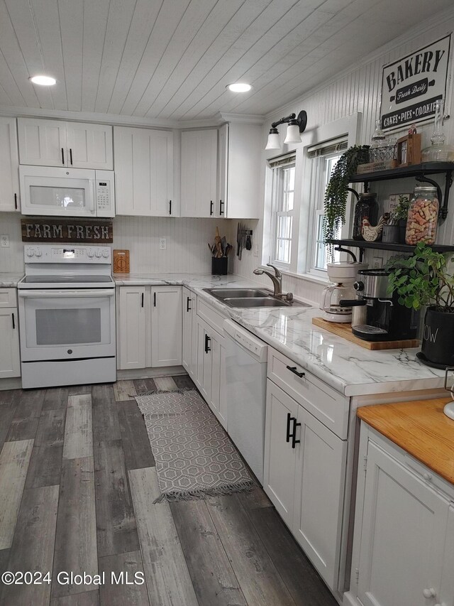 kitchen with white cabinets, dark wood-type flooring, white appliances, and sink