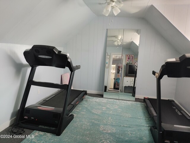 workout room with carpet flooring, lofted ceiling, and ceiling fan