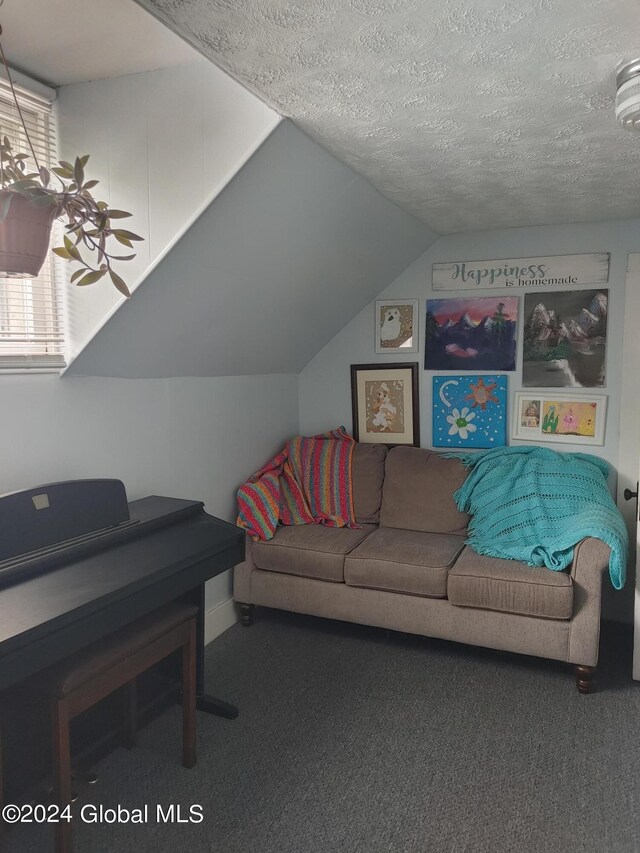 living room with carpet floors, a textured ceiling, and vaulted ceiling