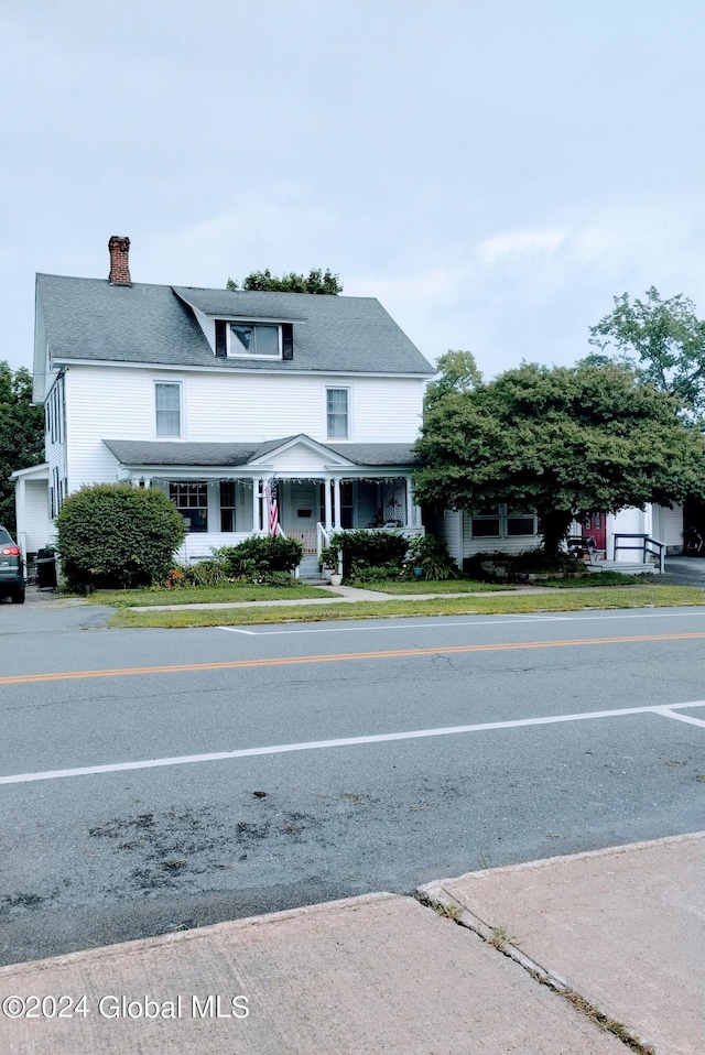 view of front of house featuring a chimney