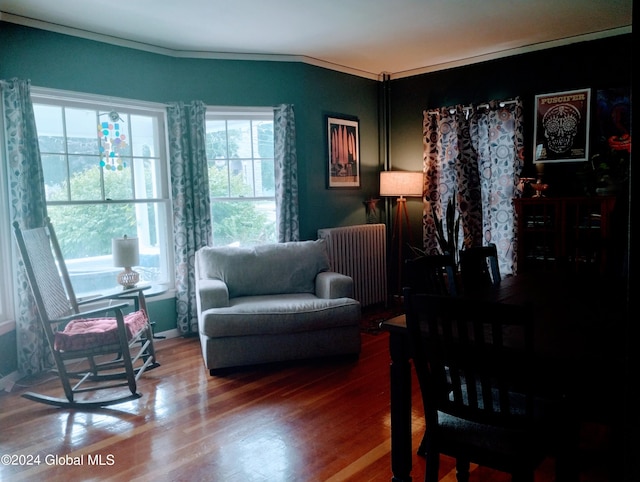 living area featuring radiator and wood finished floors