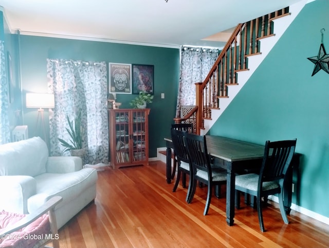 interior space featuring baseboards, wood finished floors, and stairs