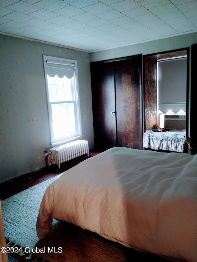 bedroom with cooling unit and radiator heating unit