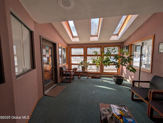 sunroom featuring a wealth of natural light and vaulted ceiling with skylight