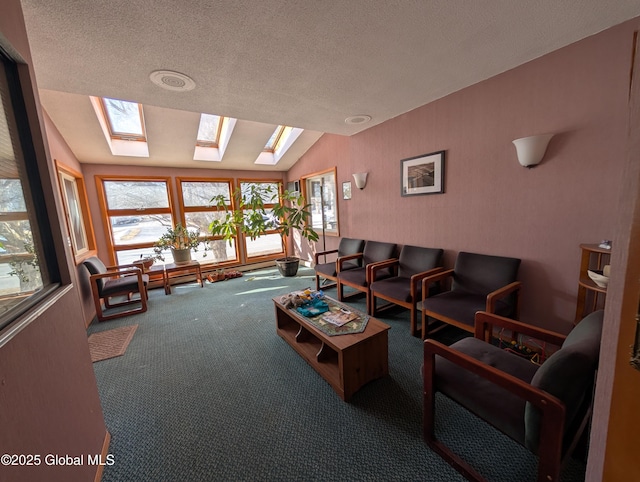 living room with vaulted ceiling with skylight, carpet flooring, plenty of natural light, and a textured ceiling