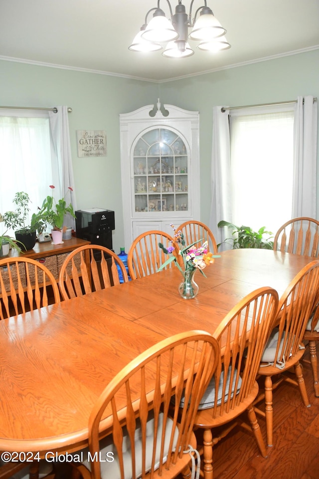 dining room with hardwood / wood-style floors, plenty of natural light, and ornamental molding