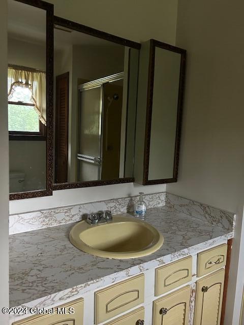 bathroom with vanity and an enclosed shower