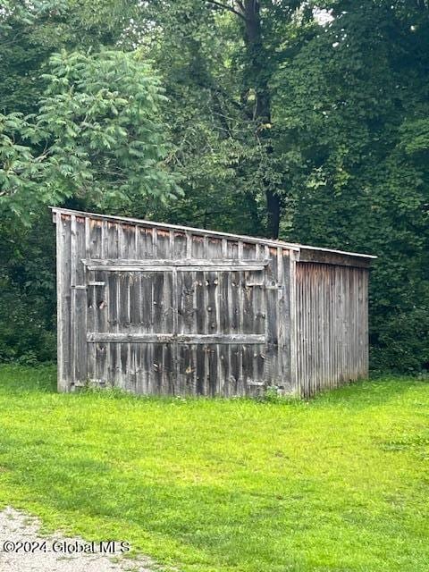 view of outdoor structure with a wooded view