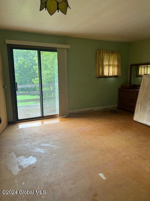 unfurnished room featuring baseboards