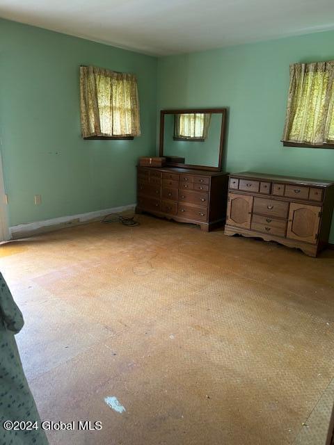 unfurnished bedroom with baseboards