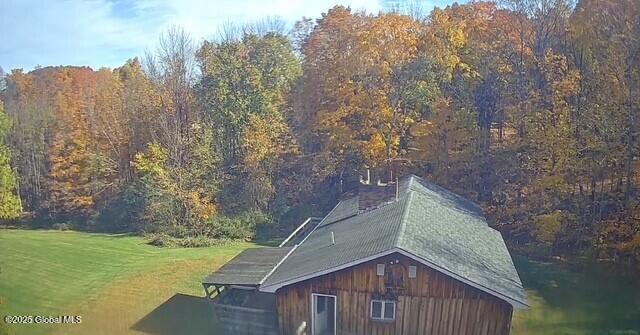 aerial view featuring a wooded view