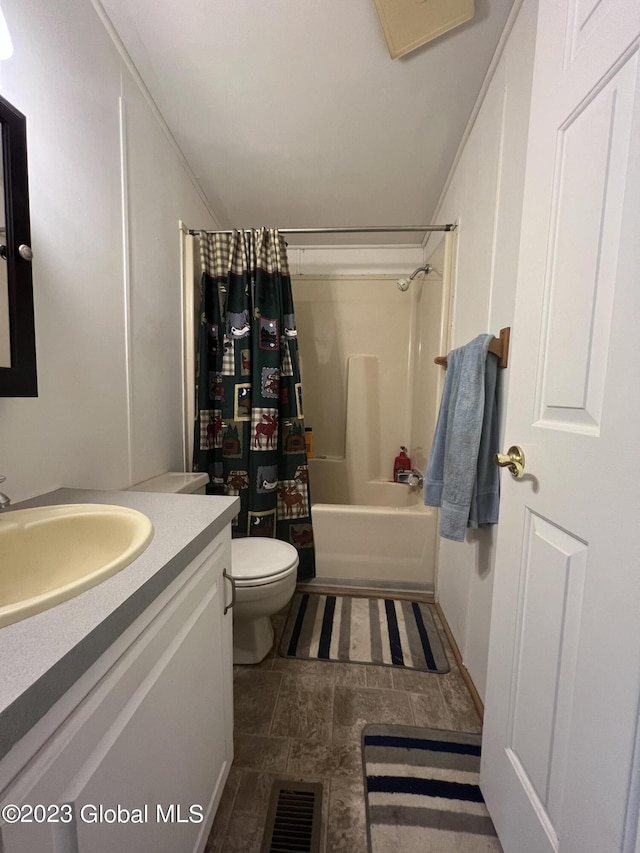 bathroom with shower / bath combo, visible vents, vanity, and toilet