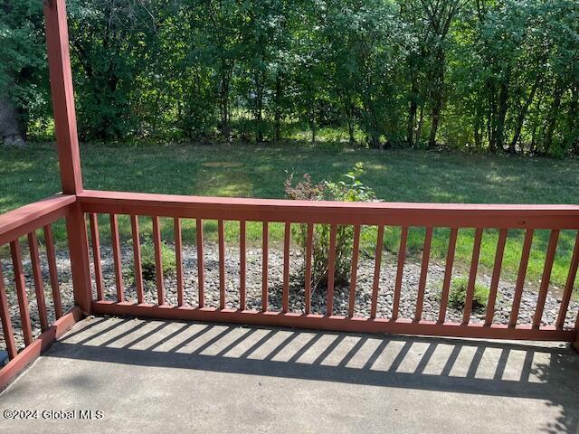 wooden terrace with a lawn