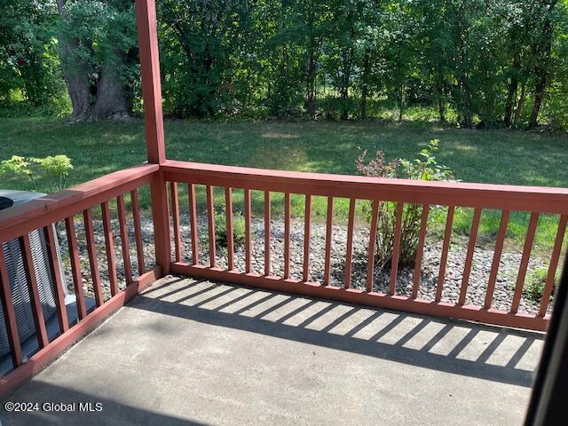 wooden terrace with a lawn