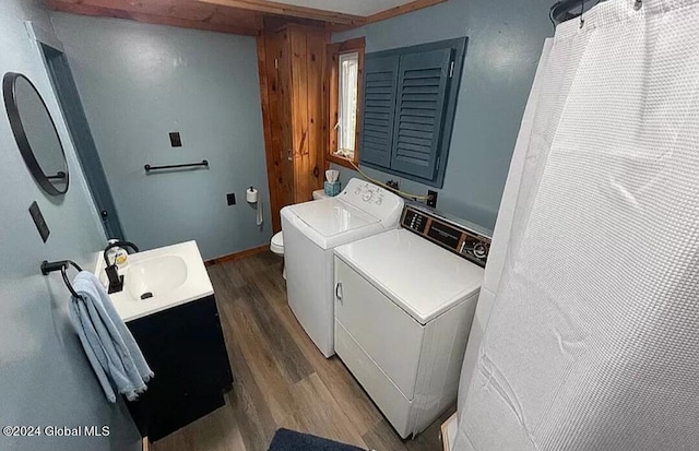 laundry room with dark hardwood / wood-style flooring, sink, and washer and clothes dryer