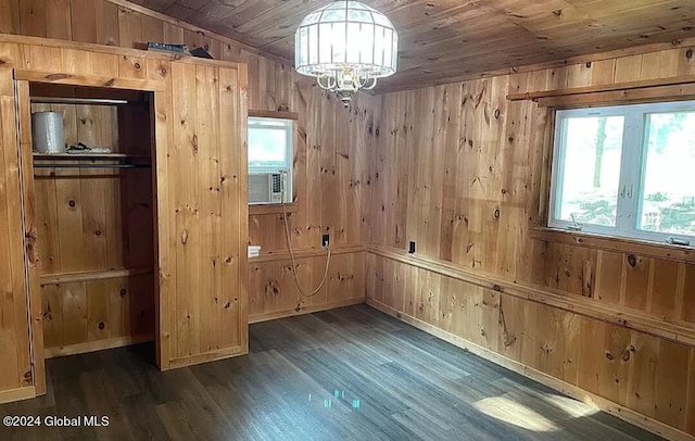 interior space with wood ceiling, wooden walls, dark hardwood / wood-style floors, and a chandelier