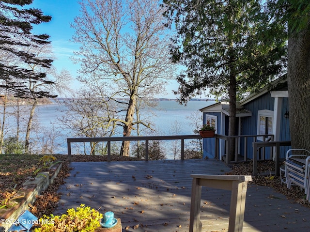 wooden deck featuring a water view