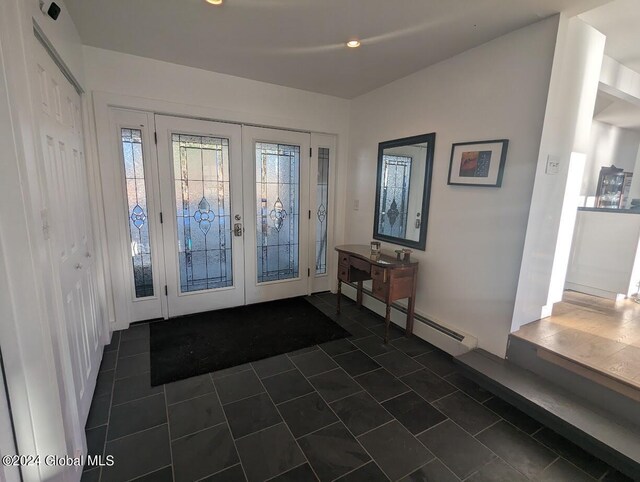 tiled foyer entrance with french doors and a baseboard heating unit