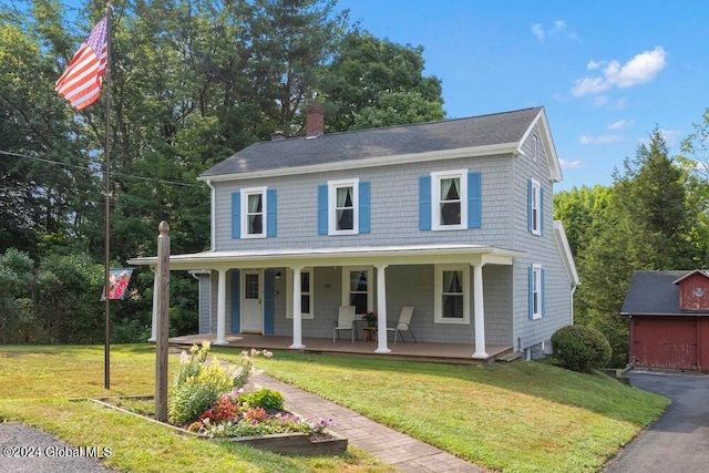 view of front of house with covered porch and a front lawn